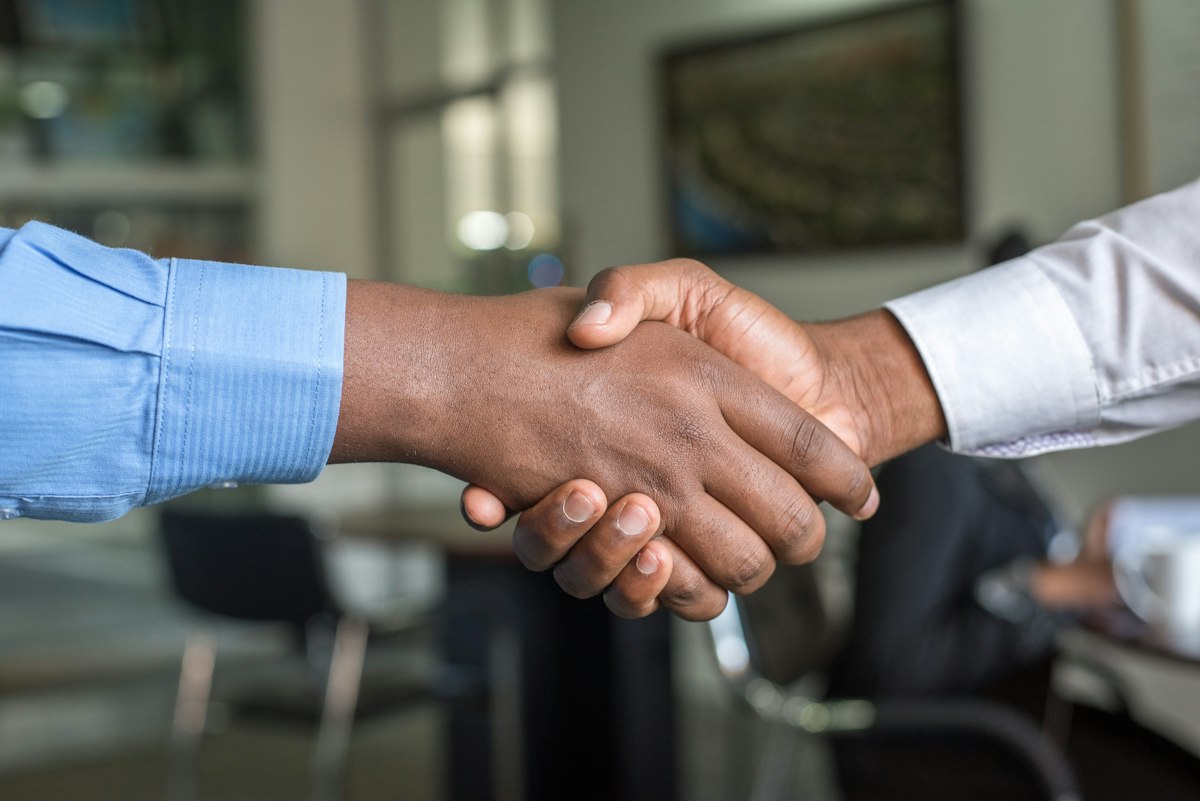 Two business professionals shaking hands on a deal